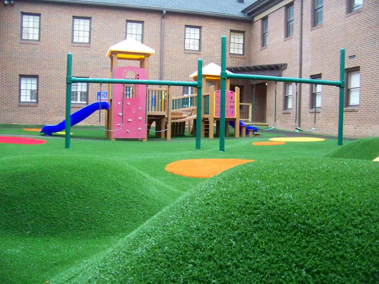 Hilly artificial turf playground by Southwest Greens East Bay